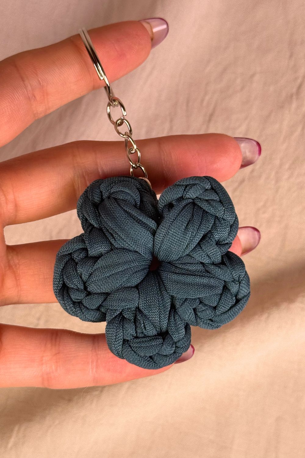Dettaglio ravvicinato del portachiavi fiore petrolio Made By Hand, che mette in risalto la texture e la qualità della lavorazione