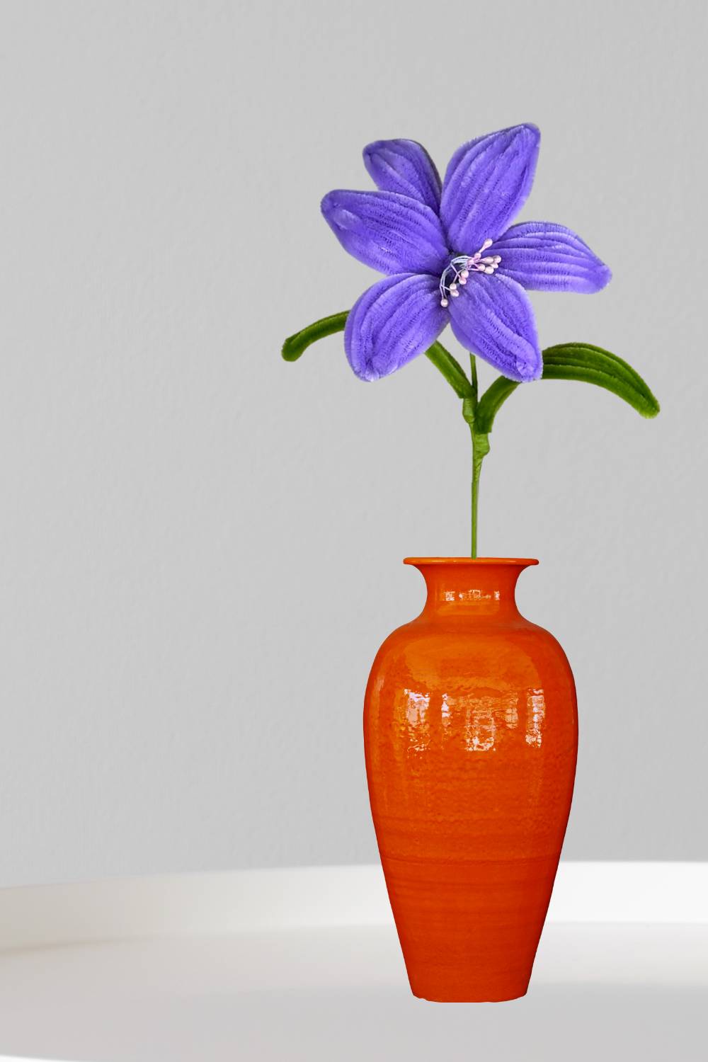 Giglio lilla in scovolini in un vaso arancione su sfondo neutro - il fiore è fatto a mano 34 cm – fiore artigianale decorativo realizzato in Italia da Made By Hand.